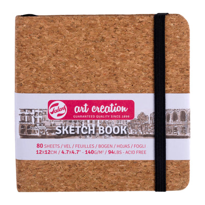 Cork sketchbook with black elastic band on a white background