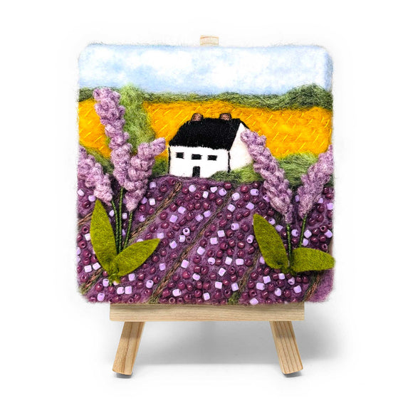 Felted landscape with a house and lavender on a small easel