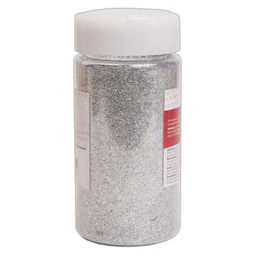 Jar of silver glitter with a white lid on a white background