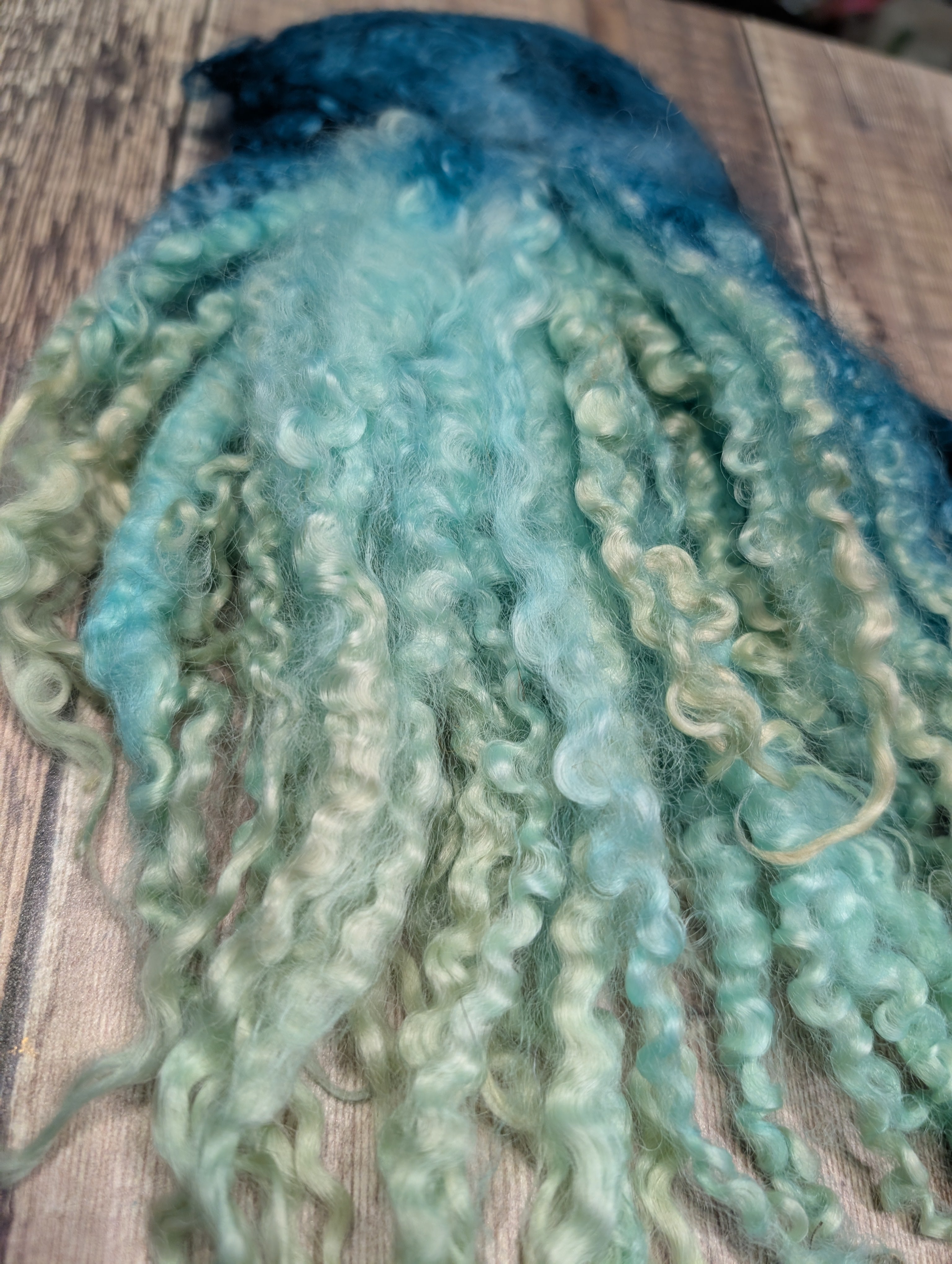 Beautiful hand-dyed curly locks colour green graduating through to turquoise and cream