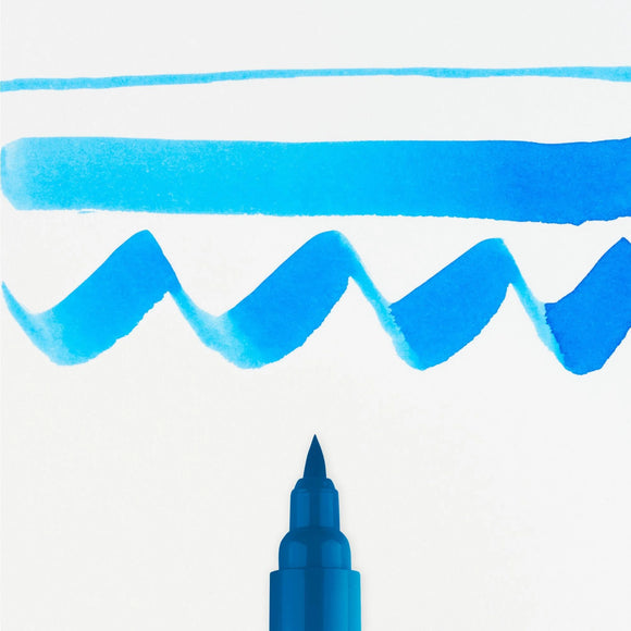 Blue marker pen with wavy line and straight line on white background