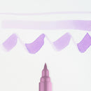 Pink marker with purple paint strokes on a light purple background