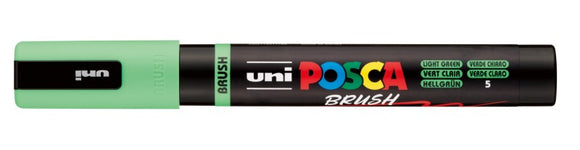 Uni Posca brush marker with green body and black cap on a white background