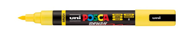 Uni Posca brush marker with yellow cap and black body on a white background