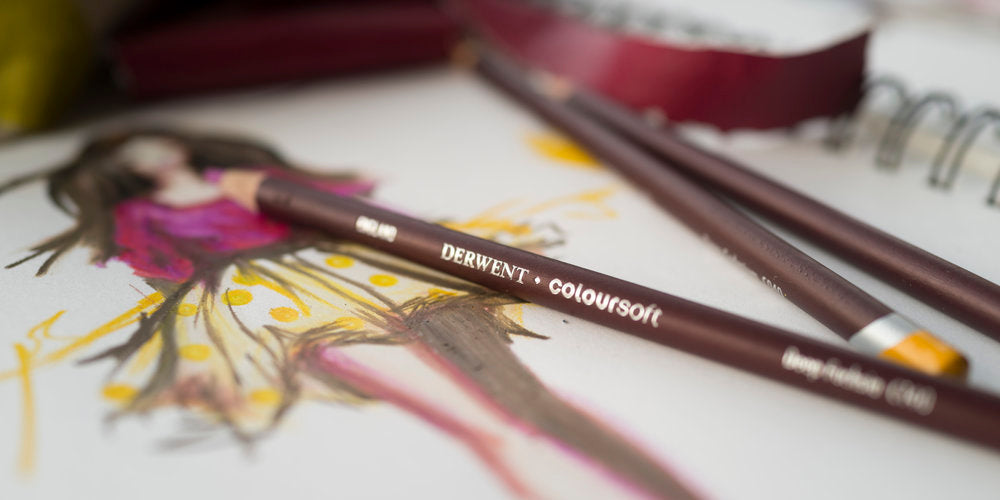 Derwent Coloursoft Pencils set 12 tin. The pencils have a soft, velvety strip, ideal for the quick application of bold colour. Contains Deep Cadmium, Bright Orange, Red, Deep Fuchsia, Indigo, Blue, Green, Lime Green, Dark Brown, Dark Terracotta, Black and White.